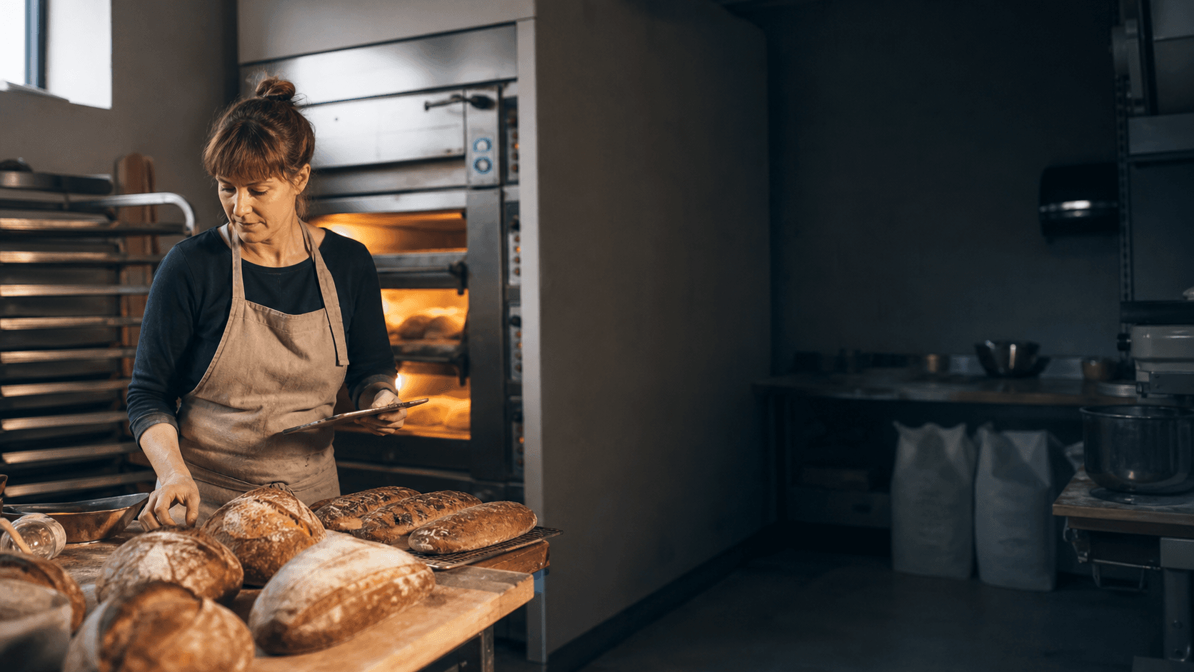 Independent bakery owner reviewing a morning production run
